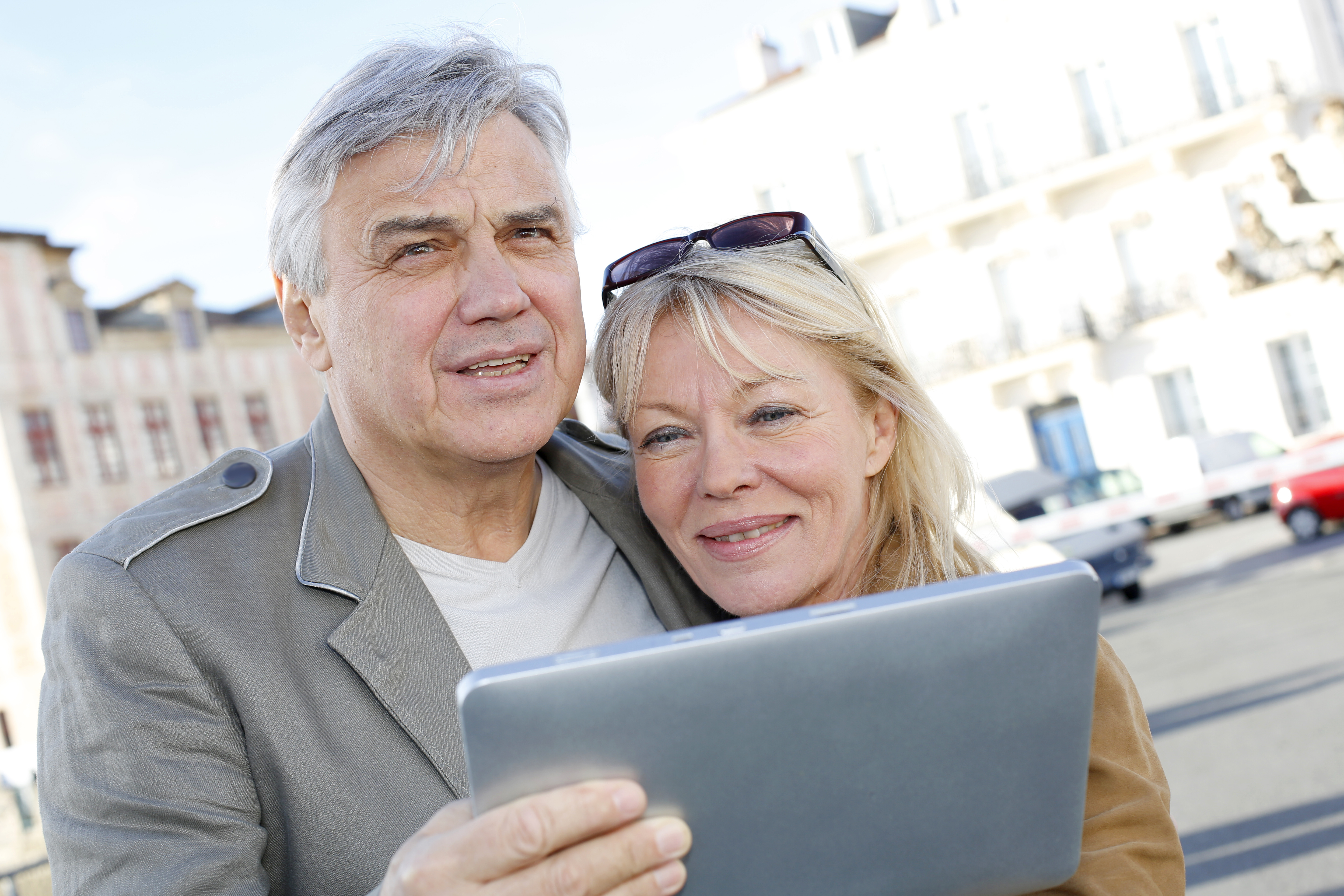 Couple on vacation using electronics