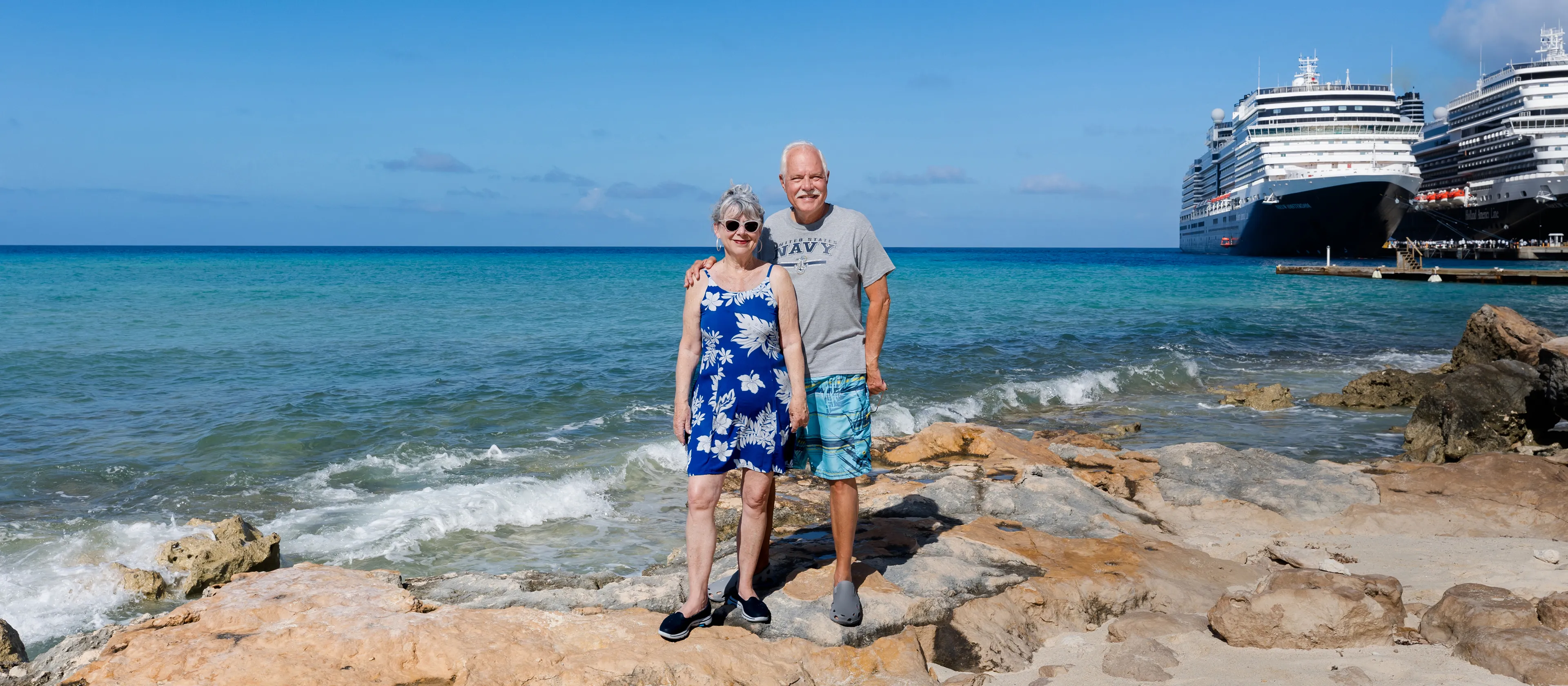 A couple standing together on the rocky beach