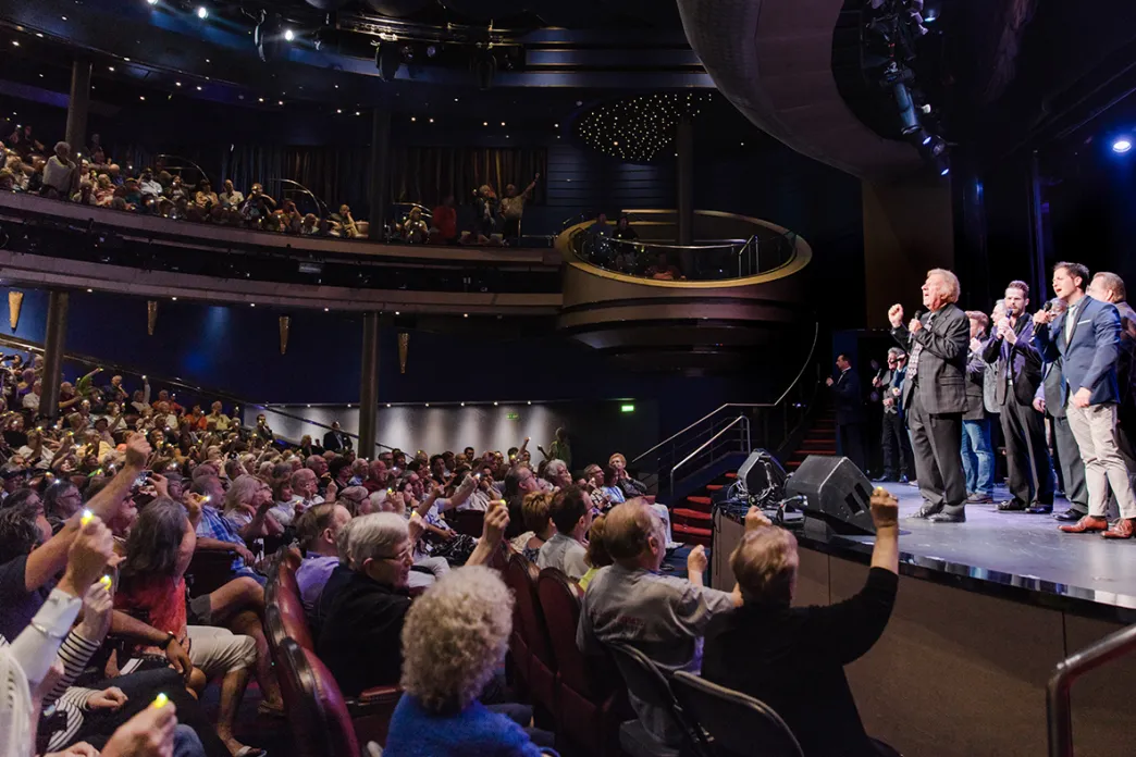 Gaither Vocal Band singing on stage to an auditorium full of people