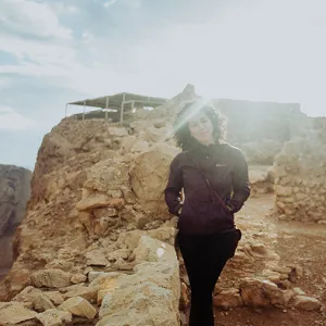 woman posing by rocks